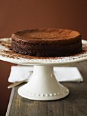 A chocolate cake dusted with cocoa powder