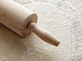 Rolled-out pastry with a rolling pin and flour