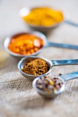 Ground caraway and assorted spices in measuring spoons