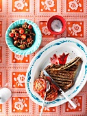 Barbecued beef steak and tomatoes served with tomato salad