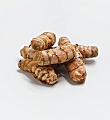 Whole Turmeric Roots on a White Background