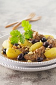Lamb tagine with potatoes, olives and pine nuts