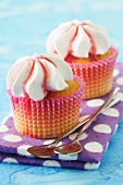 Two cupcakes on a spotted cloth