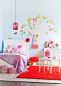 Little girl's room with a stylized tree painting on the wall