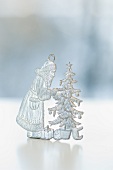 A pewter Christmas figurine: Father Christmas and a Christmas tree