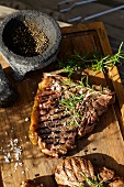 Barbecued beef steak with rosemary, salt and pepper