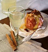 A glass of baked apple schnapps, a baked apple in the background