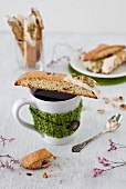 Orange Biscotti with Pistachios on a Cup of Coffee