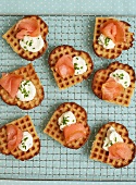 Heart-shaped waffles topped with salmon, cream cheese and chives