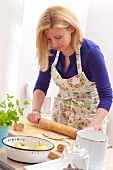 Woman rolling out biscuit dough