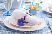 Easter place setting with willow-twig napkin ring and blue pansy