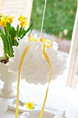 White pompom hanging over set Easter table