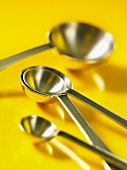 Measuring spoons on a yellow surface