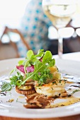 Shrimp Appetizer on White Plate on a Restaurant Table; White Wine