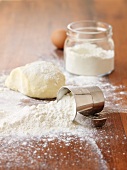 Flour and dough on a wooden surface