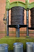 Olive oil being pressed out of baskets of crushed olives (Tunisia)
