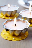 Small cake moulds used as tealights on doilies