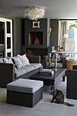 Grey wicker sofa set and coffee table in modern living room with birds'-nest ceiling lamp