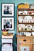Collection of china crockery in shabby chic kitchen dresser and framed photo art on wall