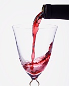 Pouring red wine into a glass