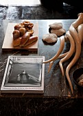 Still-life arrangement of book, pastries and hunting trophies on marble table