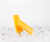 Four Orange Popsicles Stacked; White Background