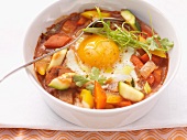 An egg cooked in the pot with vegetables