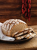 Rustic white bread, partly sliced