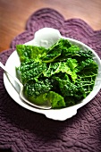 Blanched savoy cabbage on a plate with a spoon