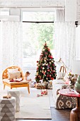 Armchair and sofa in living room; little girl sitting next to Christmas tree and piles of presents in background