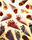 Assorted spices in baking parchment cones