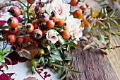 Autumnal wreath of various rosehips, roses and branches of spirea