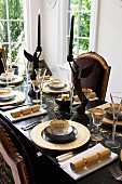 Elegant dining table set for Christmas in black and gold