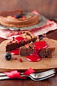 Slices of French Chocolate Cake Topped with Berry Coulis