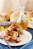 An apple dumpling stuffed with dried fruit and topped with caramel sauce