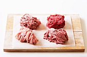 Assorted types of minced meat on a chopping board