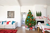 Christmas tree and presents next to fireplace in interior