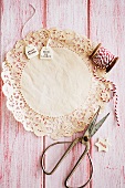 Doily, gift tags, red and white cord and scissors