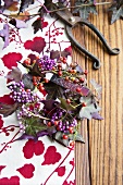 Wreath of callicarpa, tiny rosehips and purple ivy with name tag