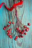 Rose hip branch with velvet ribbon