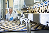 A worker sorting biscuits in a factory