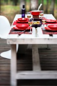 A table laid for a meal on raised decking
