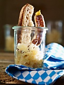 Grilled bratwurst sausages with sauerkraut, mustard and bread