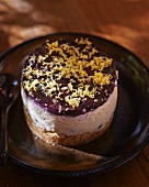 A small cheesecake with blueberries and lemon zest