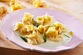 Fiocchi (filled dumplings) with Gorgonzola and pear filling on a herb sauce