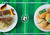 Sausages with cabbage (Germany) and salgadinhos (Brazil) with football-themed decoration