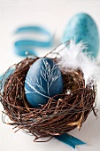 An egg painted with natural dye (red cabbage) for Easter, in an Easter nest