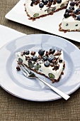 A slice of blueberry cheesecake with a muesli base