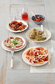Four assorted Italian starters on plates