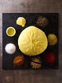 A round pat of butter, olive oil and assorted spices
